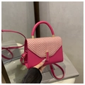 Magenta crossbody bag with woven flap and gold hardware in a stylish handheld display - Rose Pink