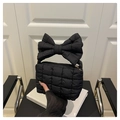 Detail of black quilted cloud bag with a large bow handle and golden metal zipper - Black