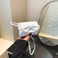 Mini white crossbody bag featuring a large decorative bow and delicate lace trim detail - White
