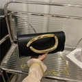Black leather crossbody bag with oversized gold metal loop and delicate gold chain strap - Black