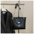 Detail of black glossy leather tote bag with gold chain straps and a small deer charm - Black