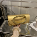 Elegant gold metallic clutch bag with oversized oval buckle and gold chain strap - Gold