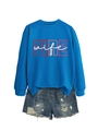 Detail of royal blue sweatshirt with red FIRE wife print and distressed denim shorts - Lake Blue (White Letters Graphic)