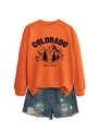 Flat lay of an orange Colorado sweatshirt paired with distressed blue denim shorts - Orange (Black Print)