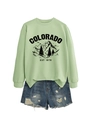 Flat lay of light green Colorado sweatshirt paired with distressed denim shorts - Olive Green (Black Print)