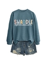 Detail of blue crewneck sweatshirt with letter print paired with ripped denim shorts - Blue Sweatshirt (White Text)