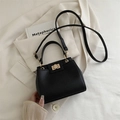 Classic black litchi pattern handbag with gold twist lock and adjustable shoulder strap - Black