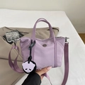 Mini lavender nylon tote bag with wide shoulder strap and cute panda charm detail - Purple