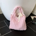 Pink bubble pleated tote bag featuring a decorative white lace bow and textured nylon fabric - Light Pink