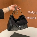 Retro black tote bag with gold chain strap and mixed leather texture in a stylish pose - Black