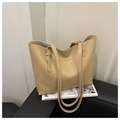 Detailed macro of beige faux leather tote with elegant Fashion & Bags embossed logo - Khaki