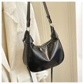 Close-up of black leather half-moon shoulder bag with silver hardware and zipper - Black