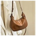 Detail of a brown oil wax leather crescent bag featuring a unique knot handle and zipper - Brown
