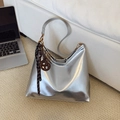 Metallic silver hobo shoulder bag with striped ribbon and brown pretzel keychain charm - With Charm / Silver
