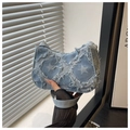 Close-up of star pattern on blue denim crescent bag with distressed frayed edges - Star - Blue