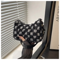Close-up of checkered tweed hobo bag with frayed edges and silver zipper detail - Black Grid