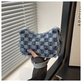 Close-up of denim shoulder bag featuring a blue checkerboard pattern with frayed edge details - Checkered Blue