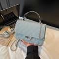 Light blue quilted leather crossbody bag with silver chain and metal turn-lock closure - Blue