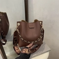 Dark brown pebble leather bucket bag with chain handle and wide patterned strap - Brown