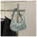 Detail of light green corduroy handbag with bow pattern and ruched shoulder strap design - Green