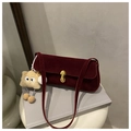 Detail view of burgundy frosted underarm bag with gold buckle and star charm - With Pendant / Red