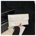 Close-up of white envelope clutch bag with glossy pleated texture on a laptop keyboard - White