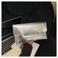 Detail of silver metallic handbag with wrinkled texture and stepped flap edge on black velvet - Silver