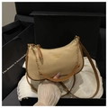 Close-up of beige lychee grain leather handbag with gold chain detail in gift box - Khaki