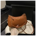 Detailed view of a caramel brown lychee pattern leather bag in a black gift box - Brown