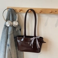 Chocolate brown tote bag with checkered bow and metallic buckle on a wooden hook - Coffee