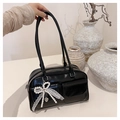 Detail of black bow shoulder bag with lace pearl charm and two front flap pockets - Black with Pendant