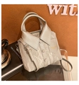 Close-up of a silver shirt-shaped bucket bag with realistic collar and button details - Silver