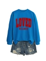 Detail van blauwe sweatshirt met rode LOVED-print en denim short met rafelranden - S / Meerblauw