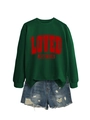 Close-up of dark green crewneck sweatshirt with vintage red LOVED print and denim shorts - Dark Green