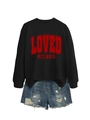 Detail of black crewneck sweatshirt with red LOVED text and distressed denim shorts - Black