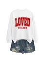 Close-up of a white crewneck sweatshirt with LOVED JOHN print and distressed denim shorts - White