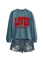 Detail of blue crewneck sweatshirt with red Loved print and distressed denim shorts - Blue
