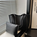 Retro black leather tote bag and pouch set shown in modern interior with sunlight - Black