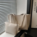 Minimalist beige tote bag set with matching small pouch in soft sunlight setting - White