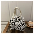 Detailed macro view of the leopard print corduroy fabric and cream woven handles - White Leopard Print
