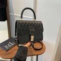 Minimalist black quilted handbag with golden twist lock and round embossed logo - Black