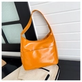 Detail of glossy orange hobo bag with Fashion logo and wide shoulder strap - Brown