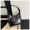 Detail of a black glossy hobo bag with a soft leather texture and golden fashion logo - Black