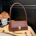 Brown crocodile embossed leather baguette bag with a gold circular metal buckle - Brown