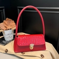 Red shoulder bag featuring crocodile pattern texture and a golden metallic clasp - Red