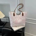 White graffiti tote bag with pink cat prints and brown handles on a black leather stool - No Pendant / Pink