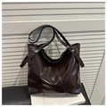 Detailed view of dark brown glossy patent leather tote with silver rivets on straps - Brown