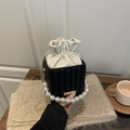 Fashionable black woven bucket bag with pearl handle and cream drawstring lining - Black