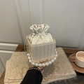 Creamy white woven bucket bag with pearl handle and golden chain strap detail - Off White