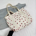 White corduroy tote bag with red strawberry print and cream ribbon handles - White